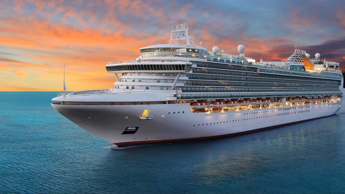 A cruise ship sailing at sunset