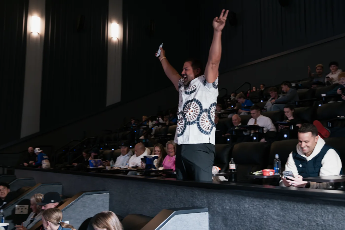 A movie premiere winner celebrating in the theater