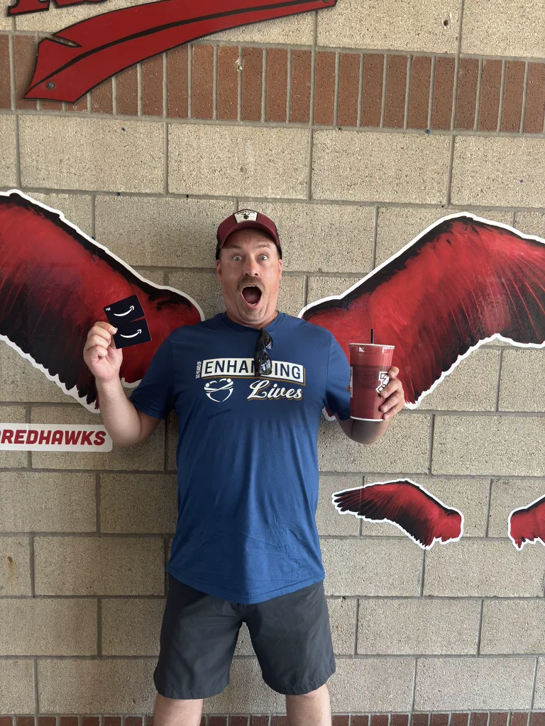 A RedHawks winner celebrating with his prize