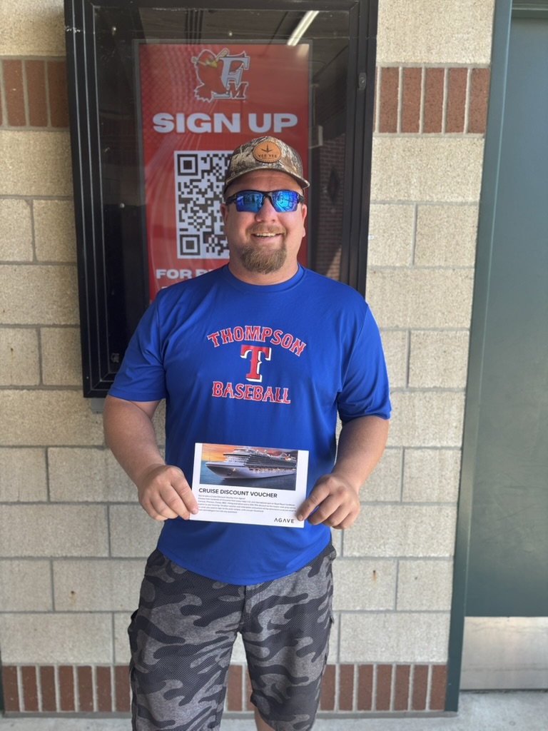 A winner holding his cruise travel reward
