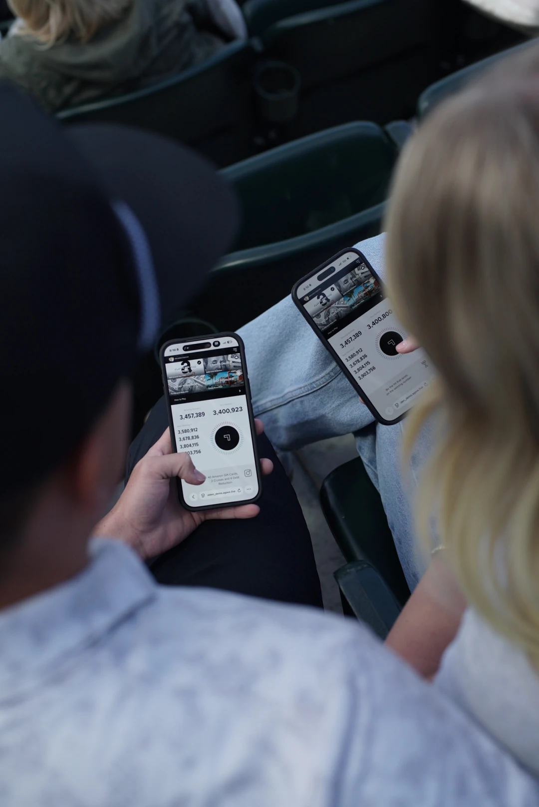 Fans playing Agave on their phones in the stands